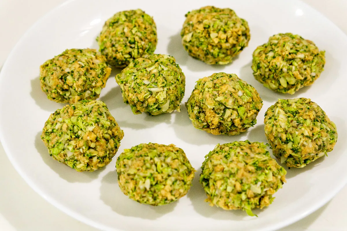 broccoli meatballs on a plate ready to be cooked