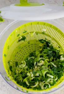 sliced leek in a salad spinner