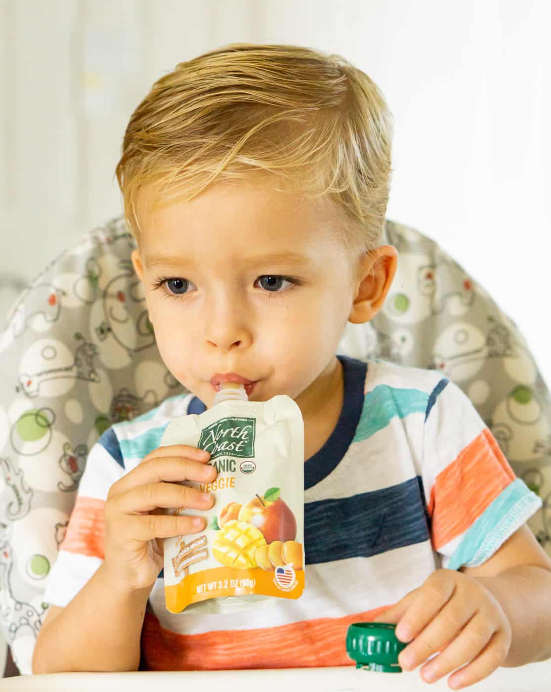 toddler eating from a pouch