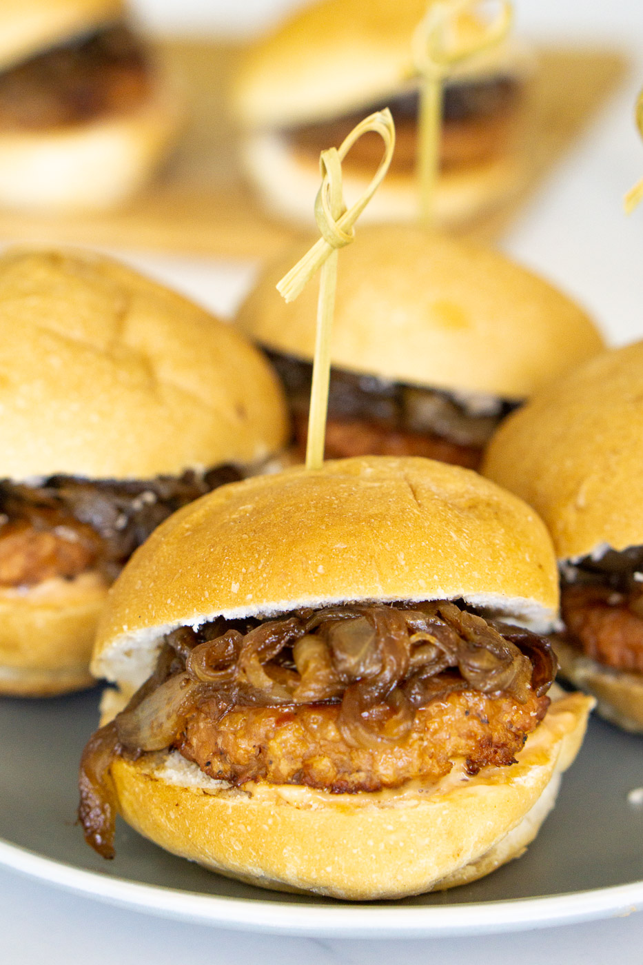 sausage caramelized onion sliders on a plate