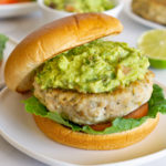 chicken burger with guacamole on a plate