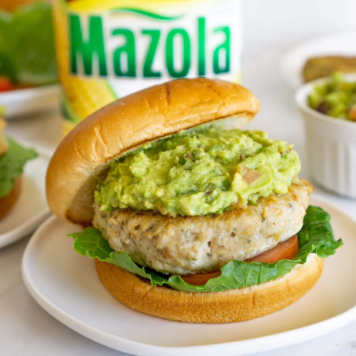 ground chicken burger topped with guacamole