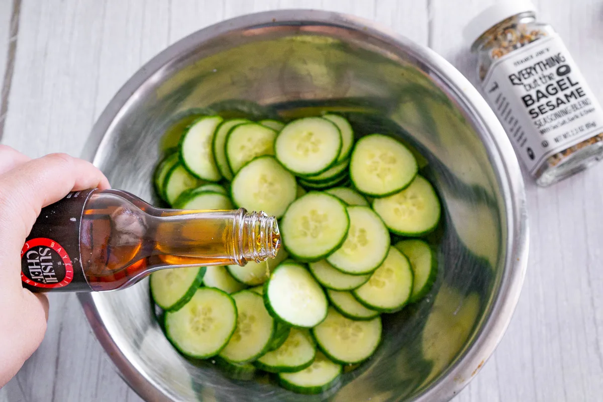 adding sesame oil to a cucumber salad without mayo