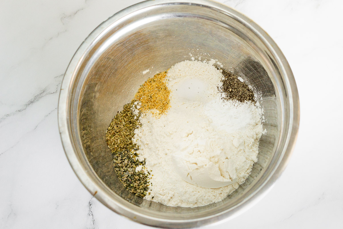 dry ingredients for cabbage fritters in a bowl: flour, salt, spices, baking powder