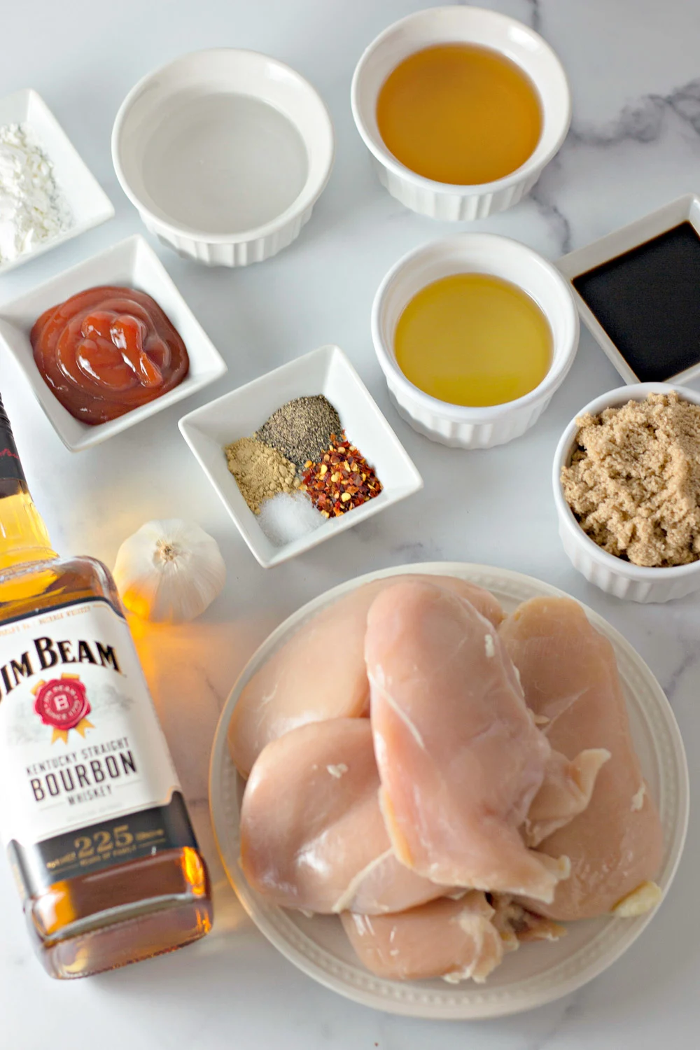 ingredients for bourbon chicken measured out in bowls