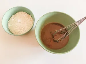 bowls of wet and dry cinnamon muffin ingredients