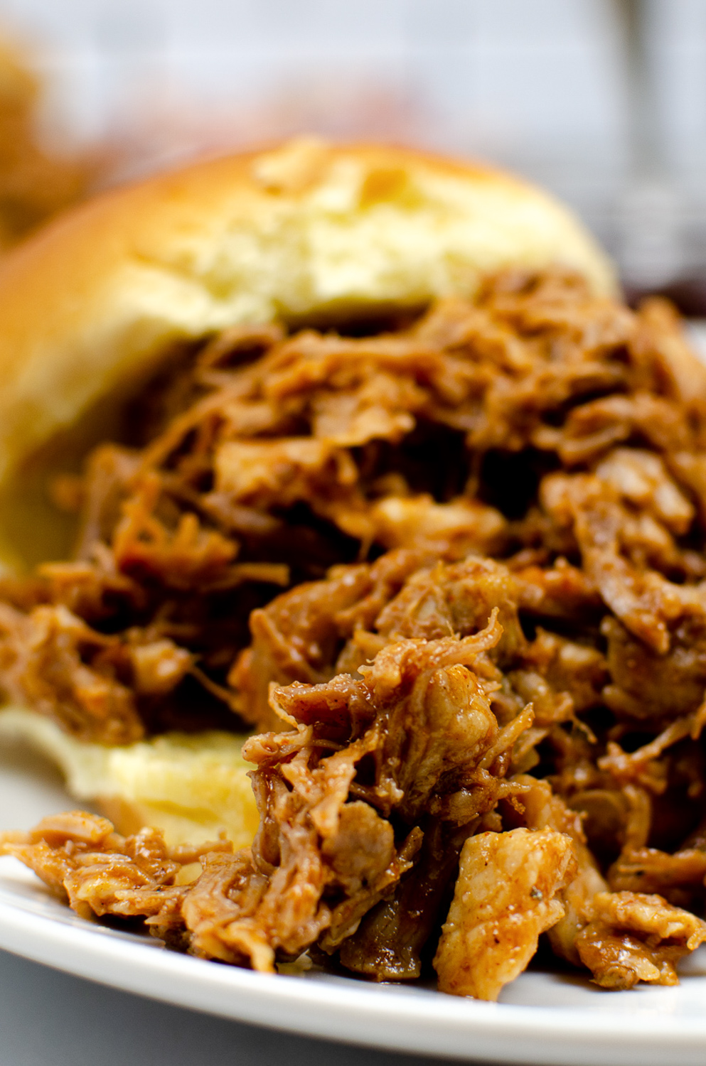 close up image of shredded pork cooked in the Instant Pot in a sandwich