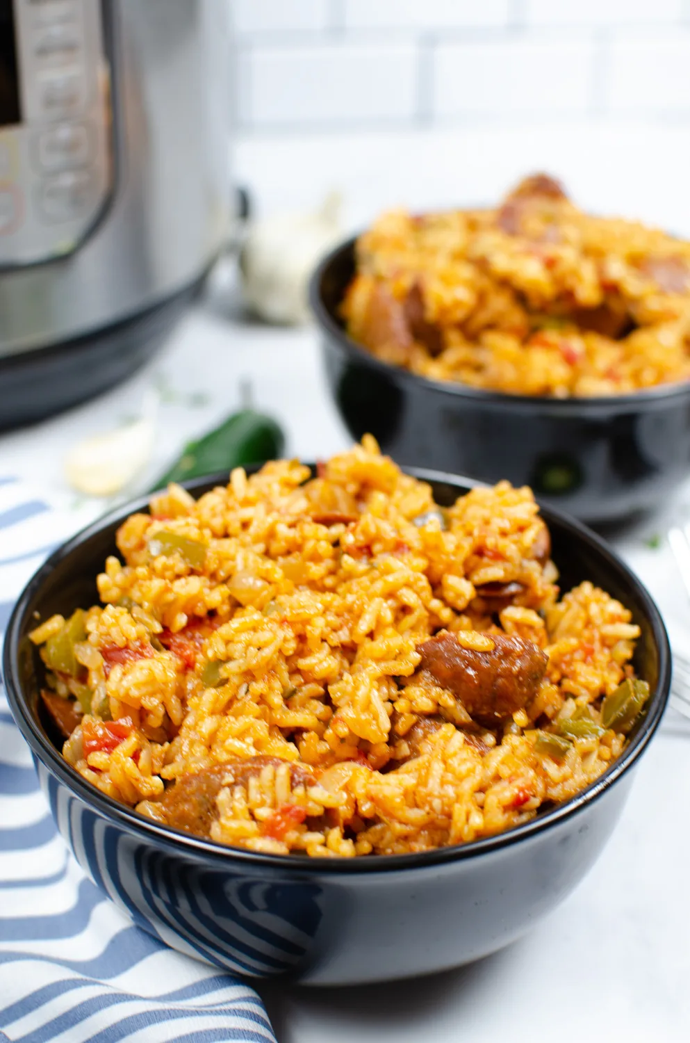 2 bowls of jambalaya in front of an Instant Pot