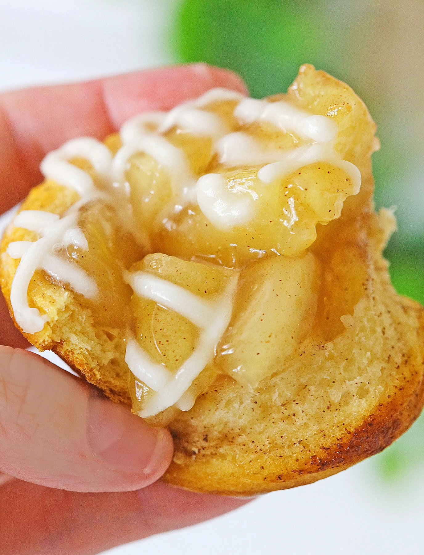 showing the inside of a cinnamon roll apple pie cup
