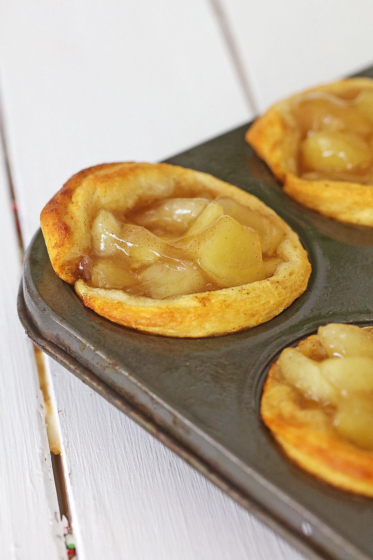 baked mini apple pies in a muffin pan