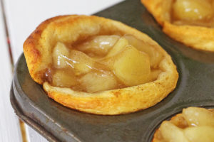 individual apple pies baked in a muffin tray