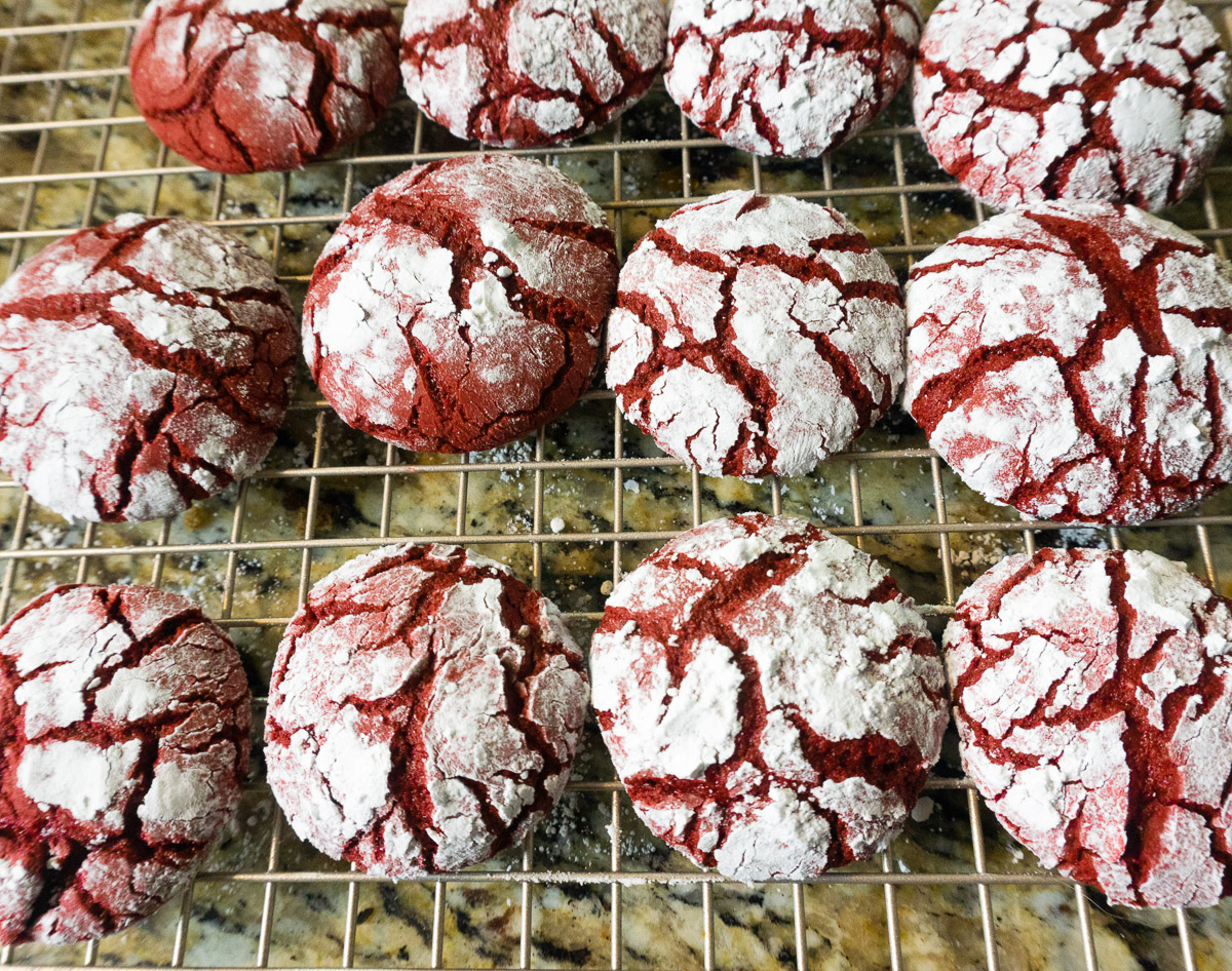 red velvet crinkle cookies cooling on a cookie rack