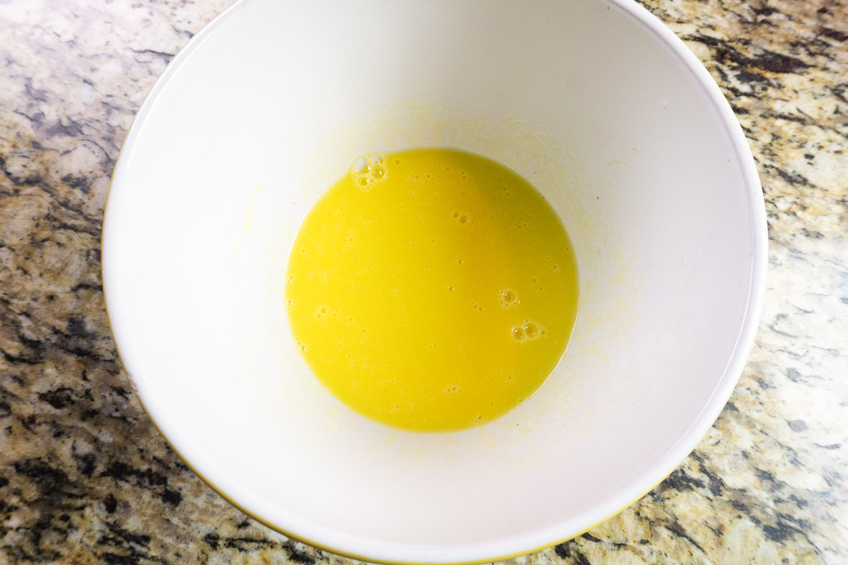eggs whisked with olive oil in a bowl