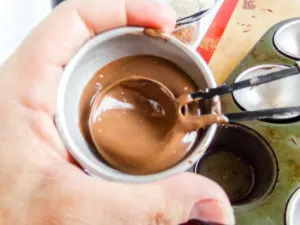 spreading melted chocolate into a hot chocolate bomb mold