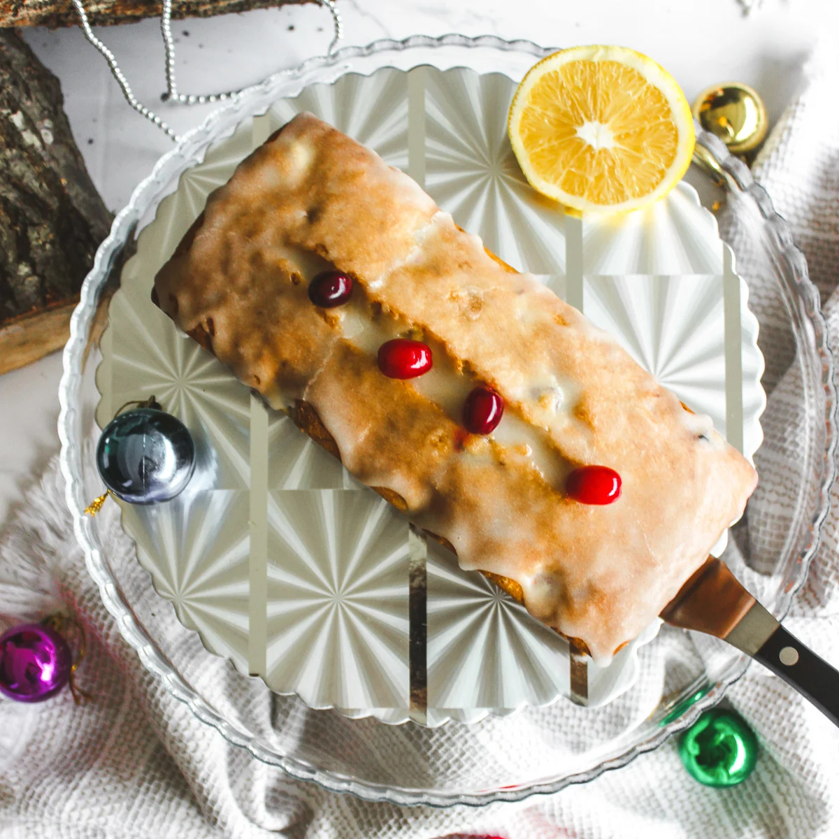 overhead shot of holiday cranberry orange pound cake decorated with cranberries
