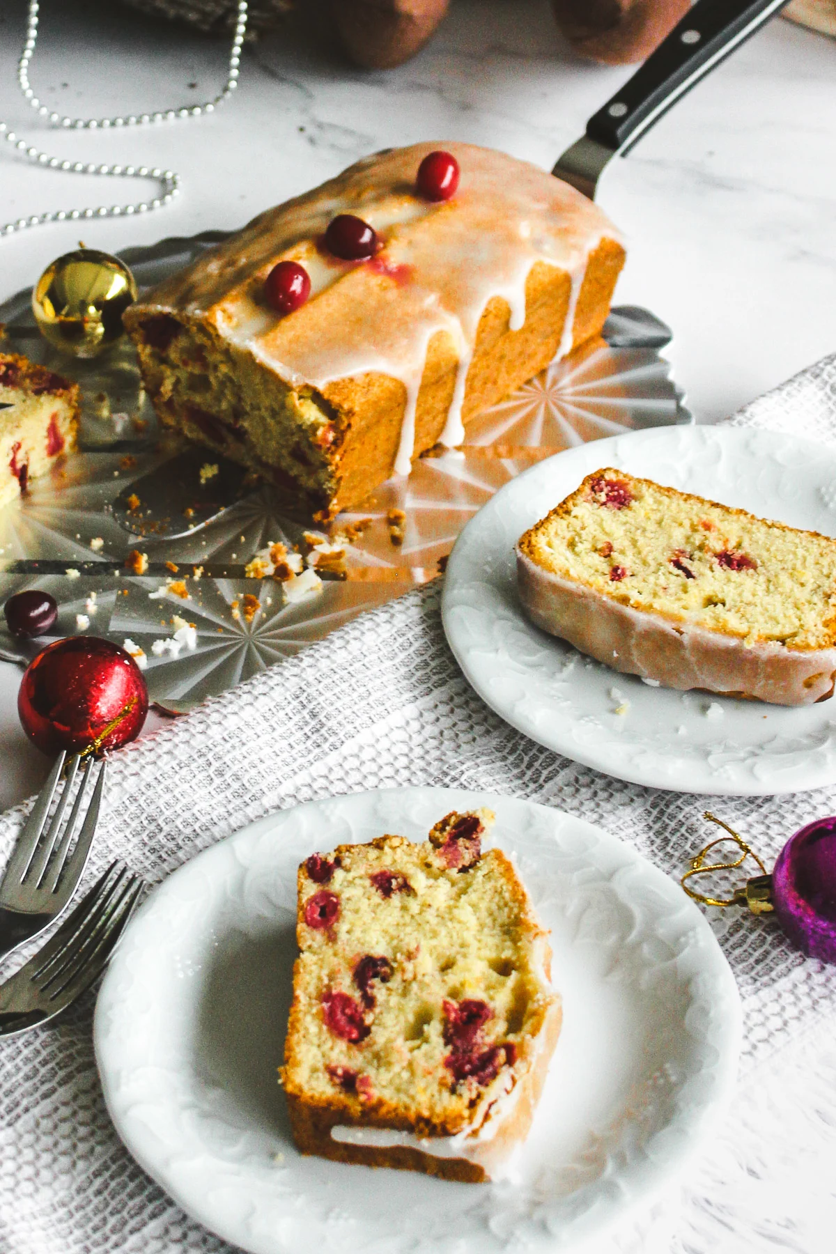 slice of holiday pound cake with cranberries with holiday decorations