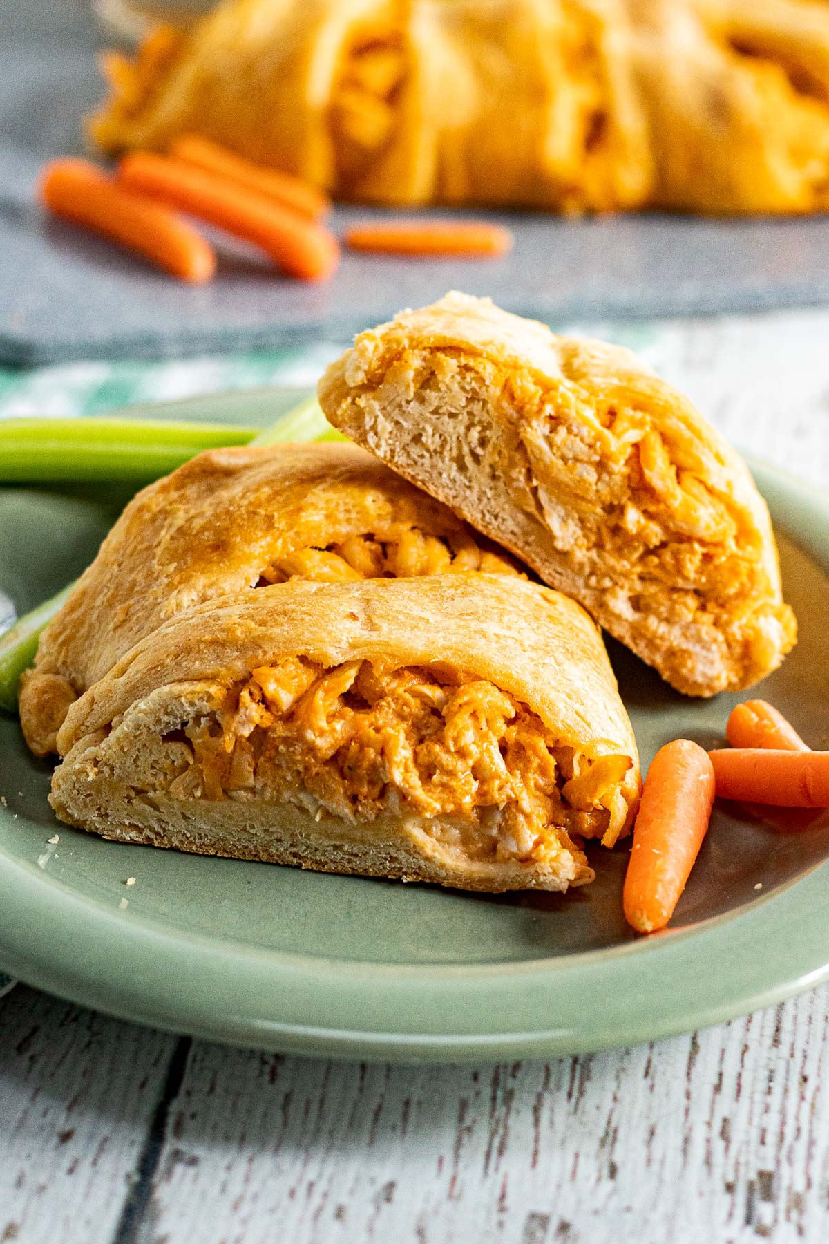 3 pieces of buffalo chicken crescent roll appetizer on a plate