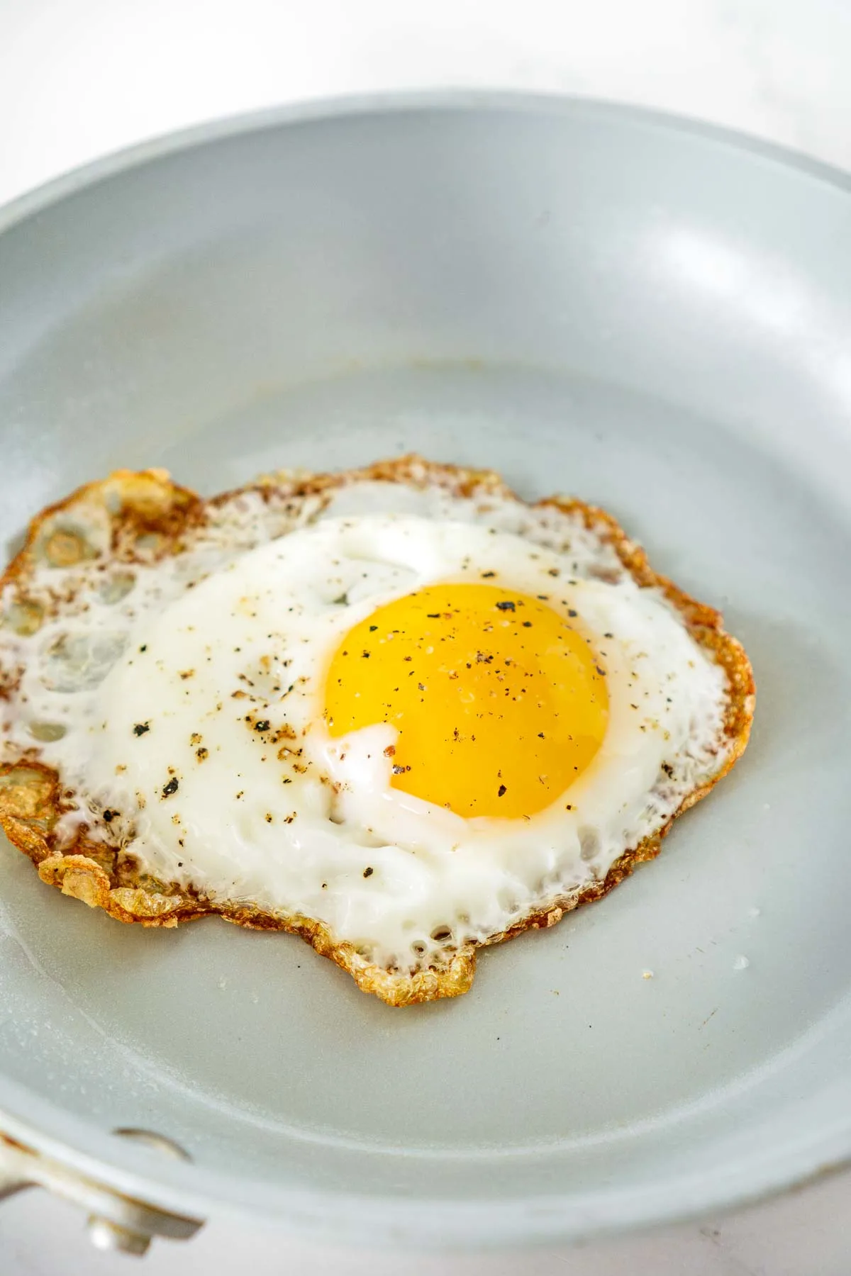 fried egg with crispy edges in a skillet
