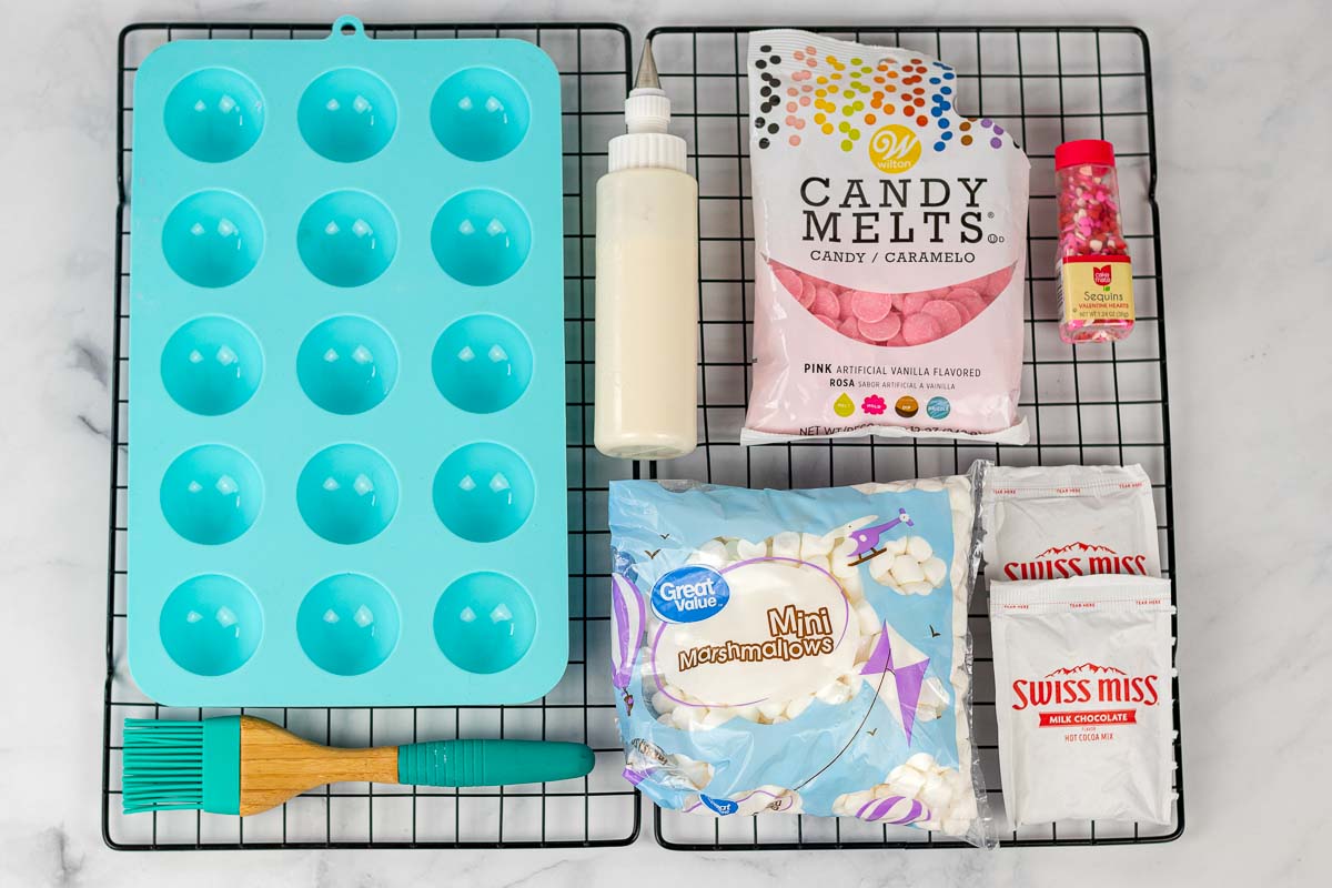 ingredients and supplies to make Valentine's Day hot chocolate bombs