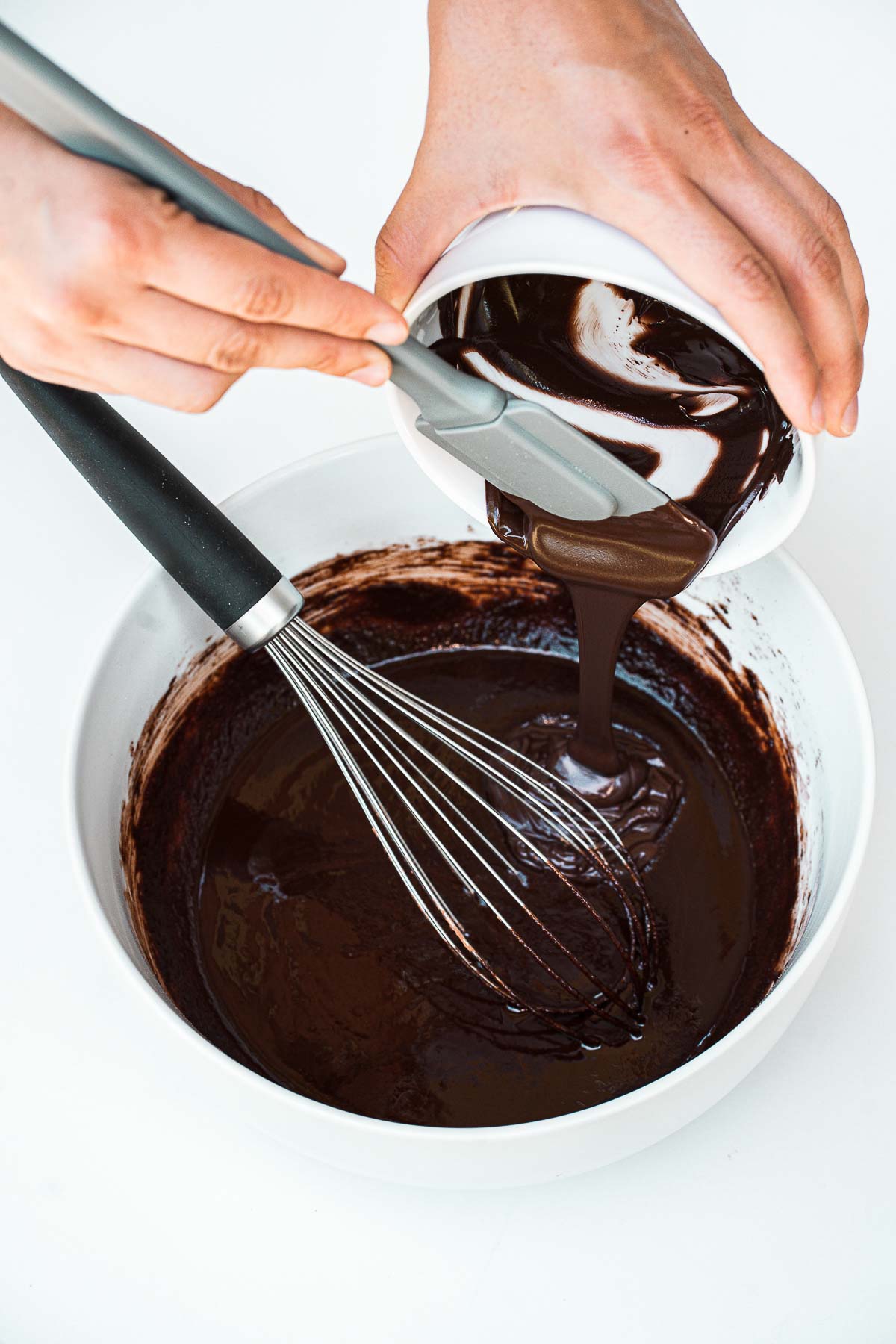 Pouring melted chocolate into a bowl.