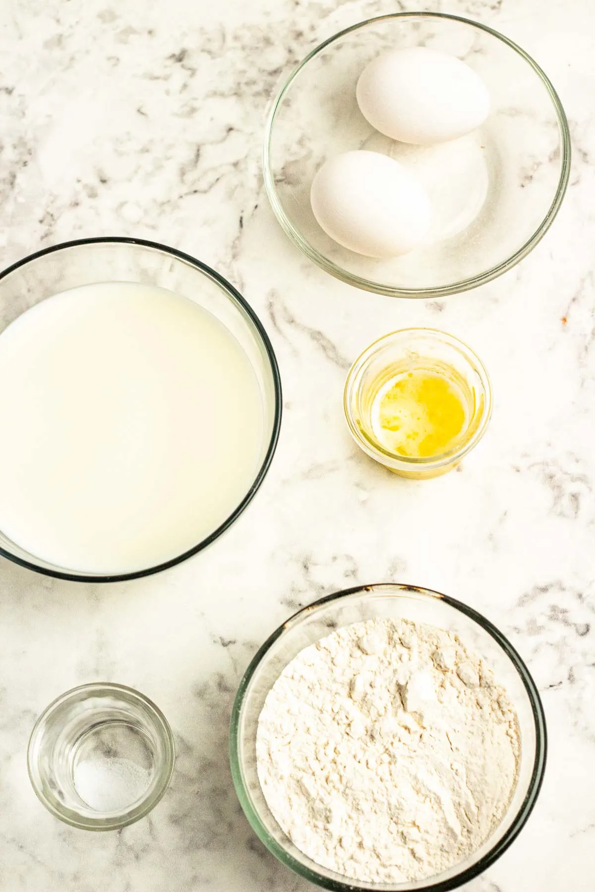 Ingredients for savory crepes: flour, milk, eggs, oil, salt.