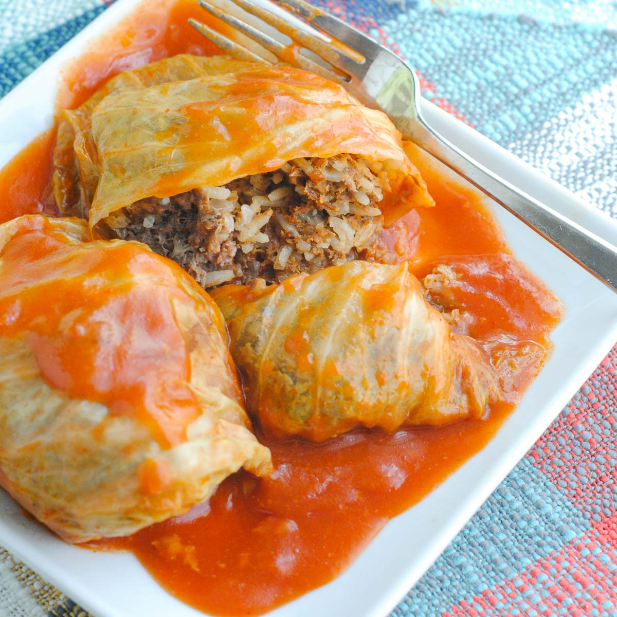 Golubtsi stuffed with ground beef and rice on a plate.