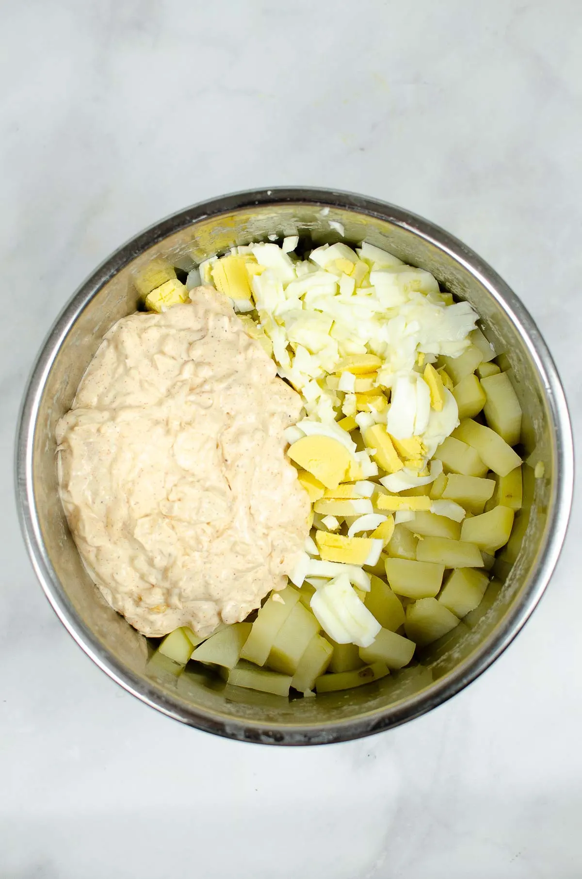 Chopped potatoes, eggs, and creamy dressing in the Instant Pot.