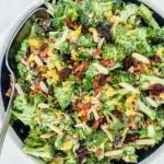 Bowl of broccoli bacon salad with cheddar, almonds, cranberries.