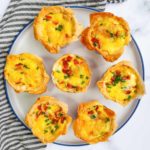 Mini phyllo quiches with sausage on a plate.