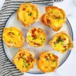 Mini phyllo quiches with sausage on a plate.