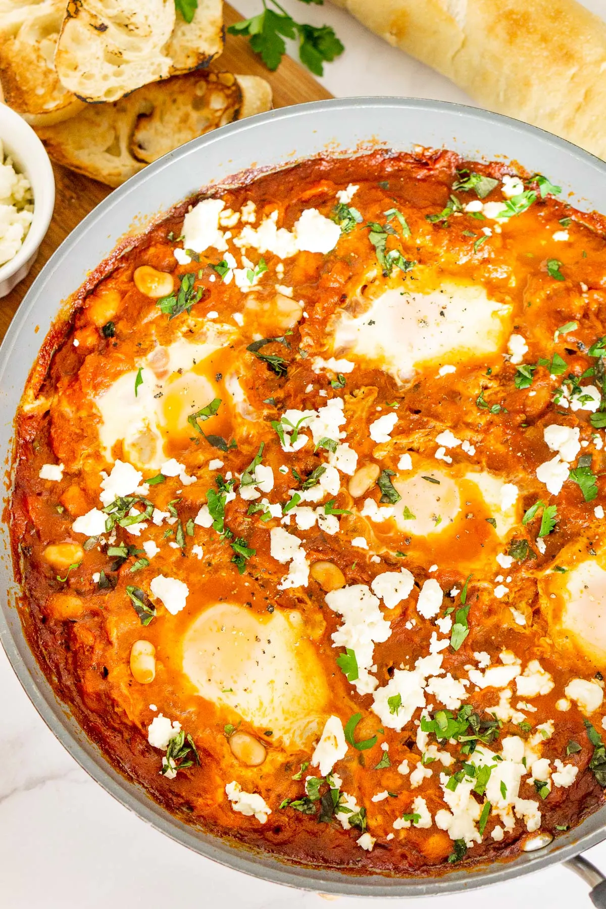 White Bean Shakshuka with feta in a pan.