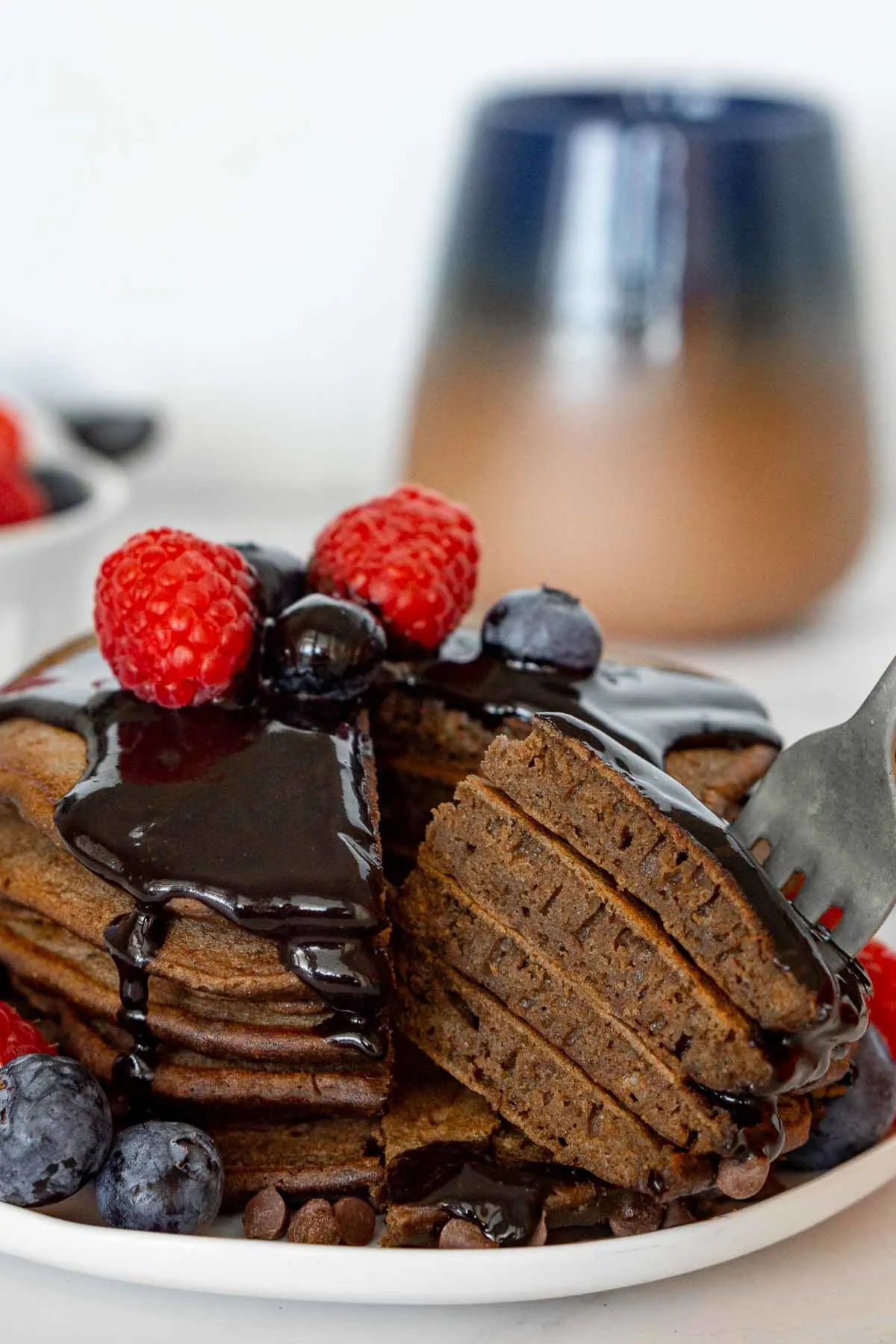Stack of chocolate protein pancakes cut open.