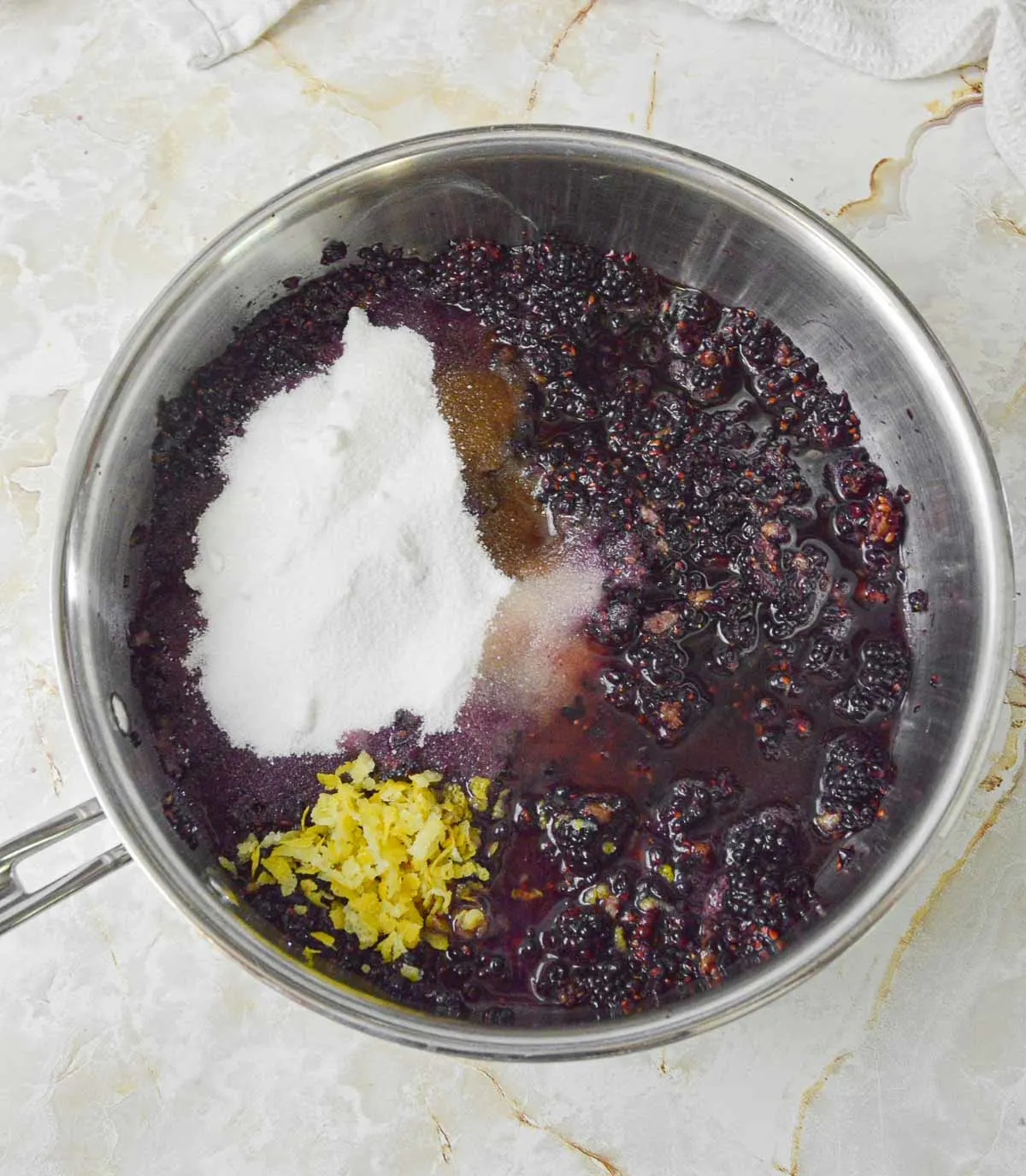 Blackberries, sugar, lemon zest, bourbon, and vanilla in a sauce pot.