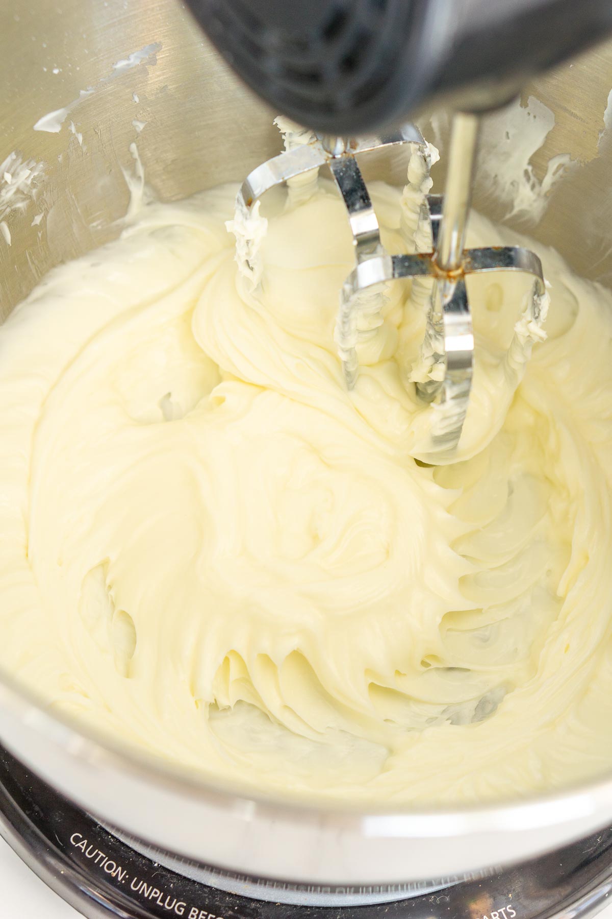 Whipping cream cheese with a stand mixer.