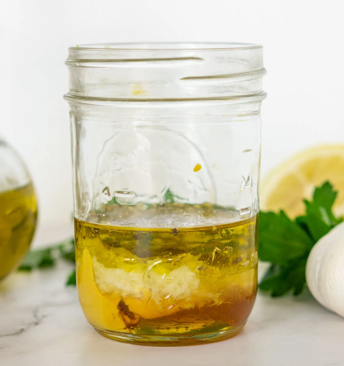 Ingredients in a jar to make lemon Dijon vinaigrette dressing for grilled asparagus salad.