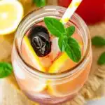 Cherry lemonade with garnish in a jar.