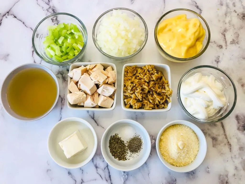 Ingredients: cooked chicken, cooked wild rice, chopped onions, celery, butter, seasonings, sour cream, parmesan, chicken broth, and cream of chicken soup.