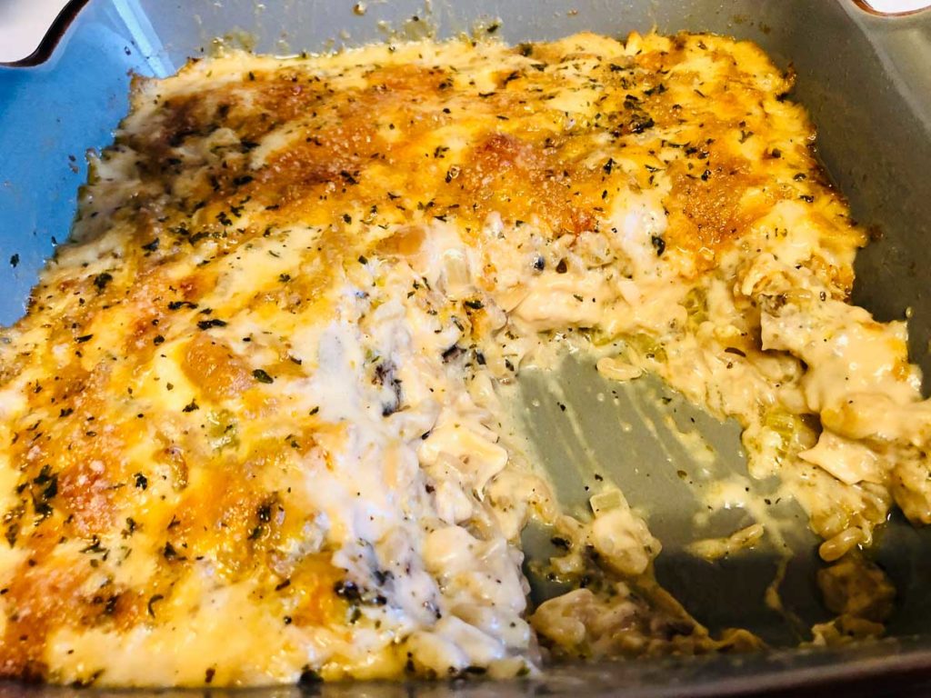 Cooked chicken and rice casserole that is golden brown on top.