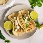 Tacos with sous vide shredded chicken and garnishes.