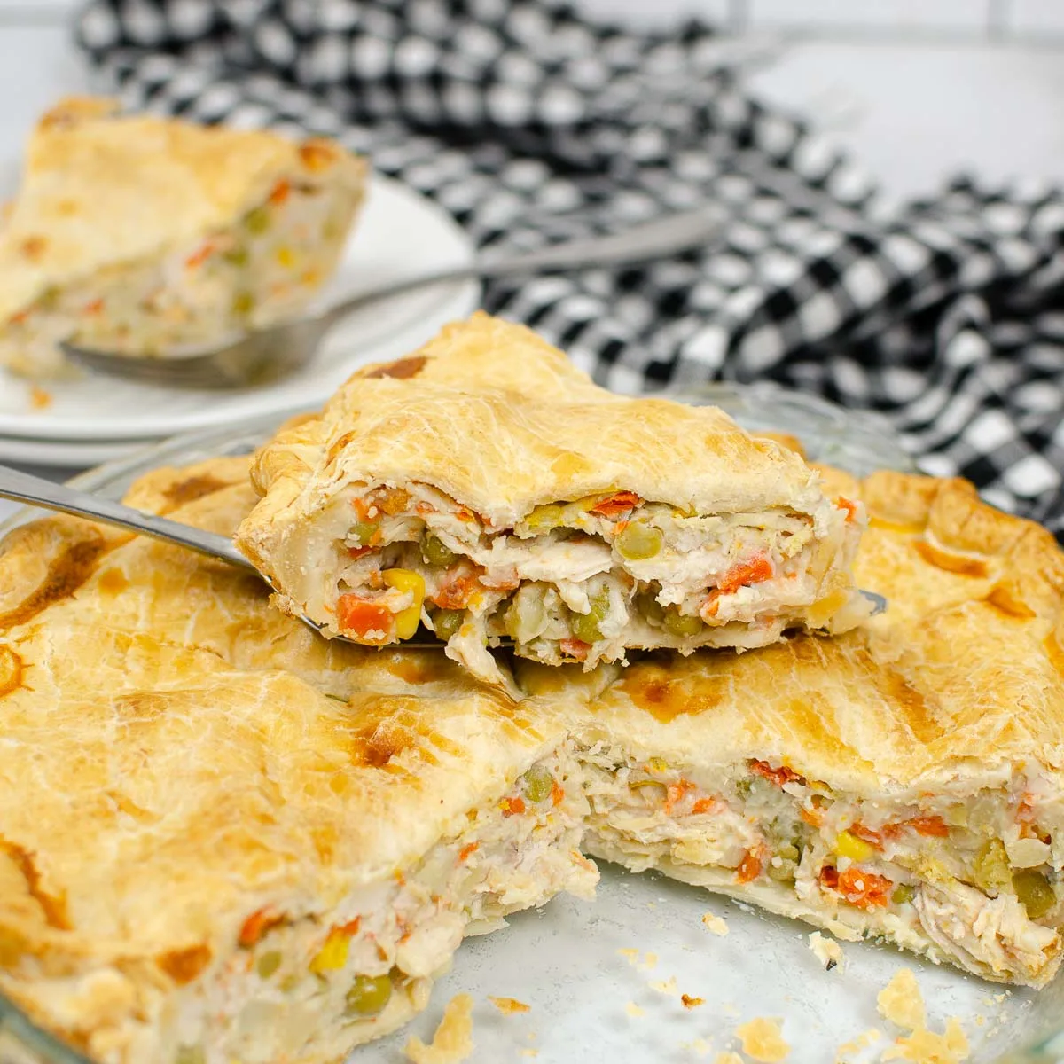 Taking out a slice of turkey pot pie with a serving spatula.