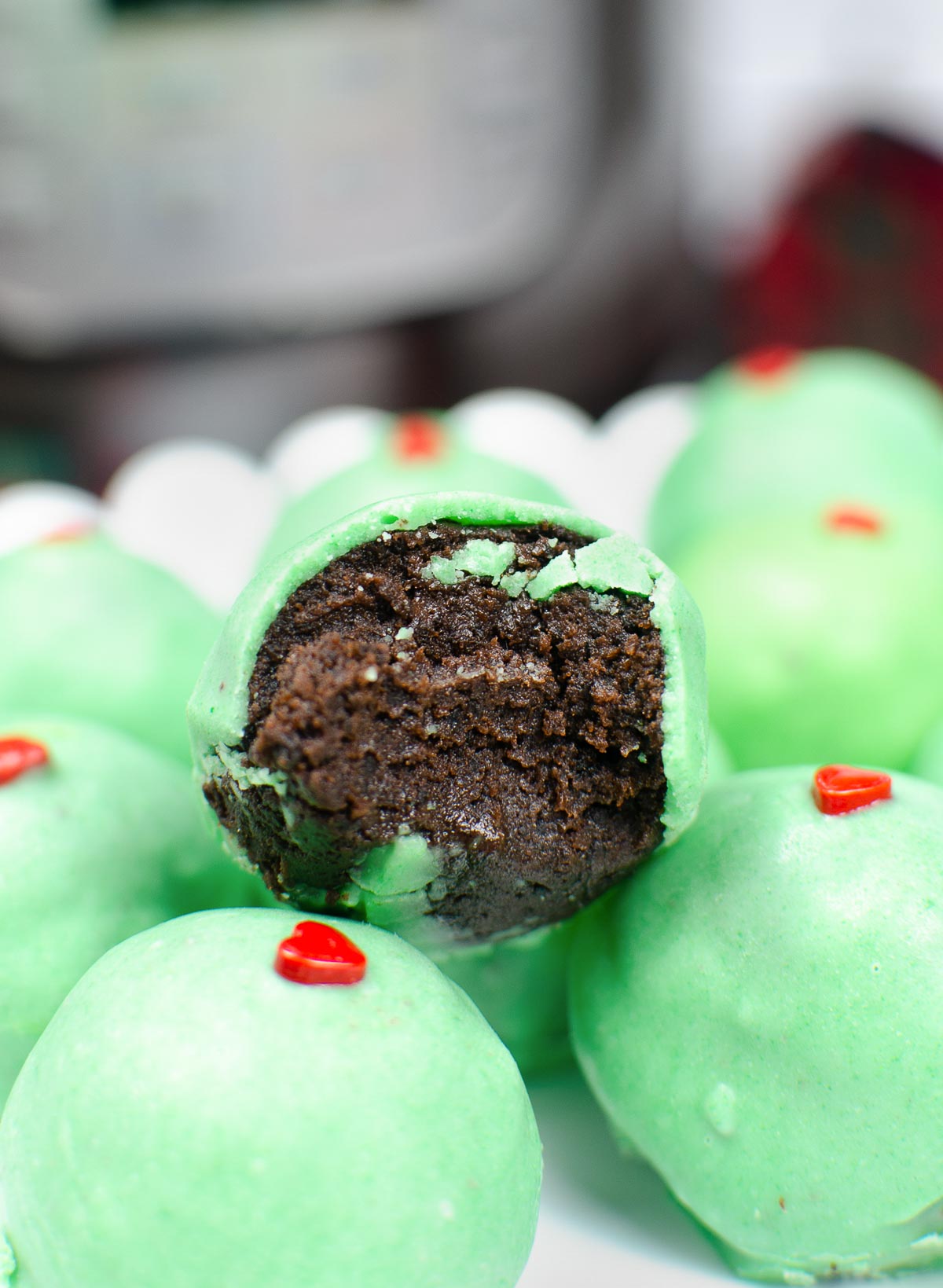 Grinch Truffle cut in half to show chocolate cake ball and texture.
