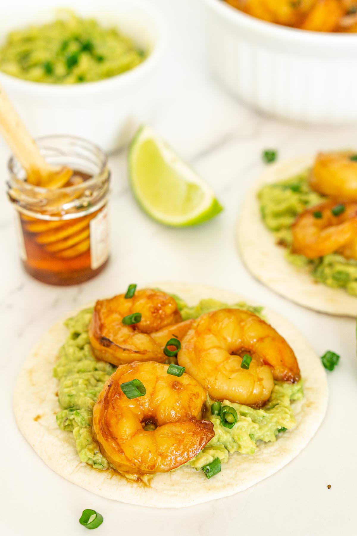 Sweet and spicy shrimp on tacos with guacamole.