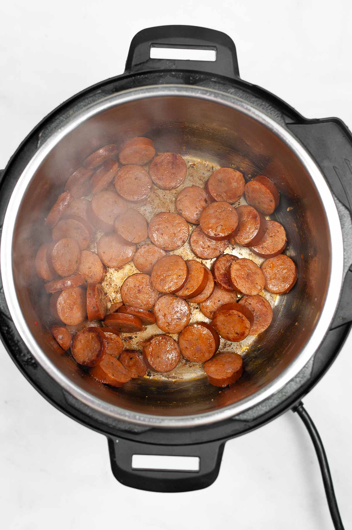 Browning andouille sausage in the Instant Pot.