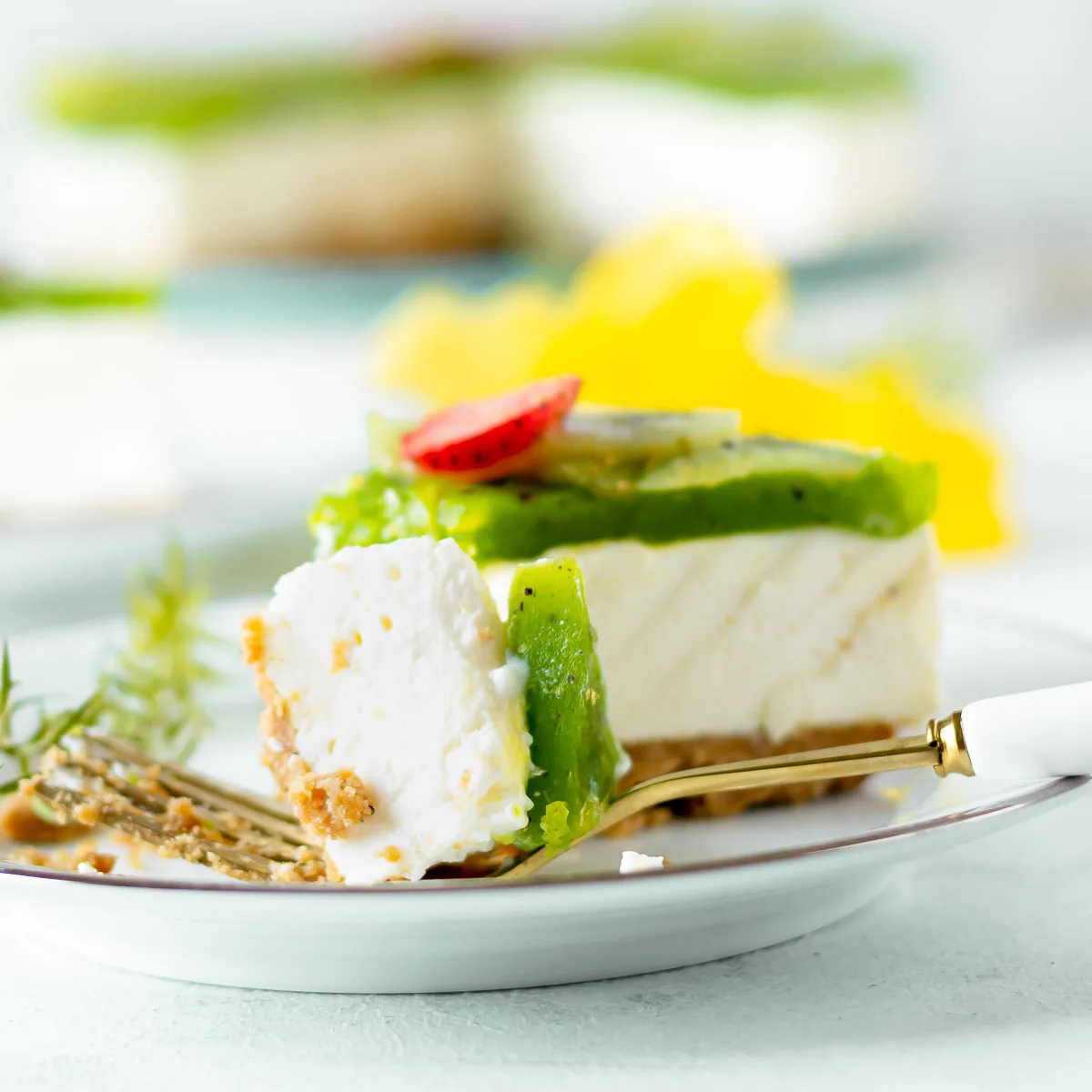 Piece of kiwi jelly cheesecake on a fork.