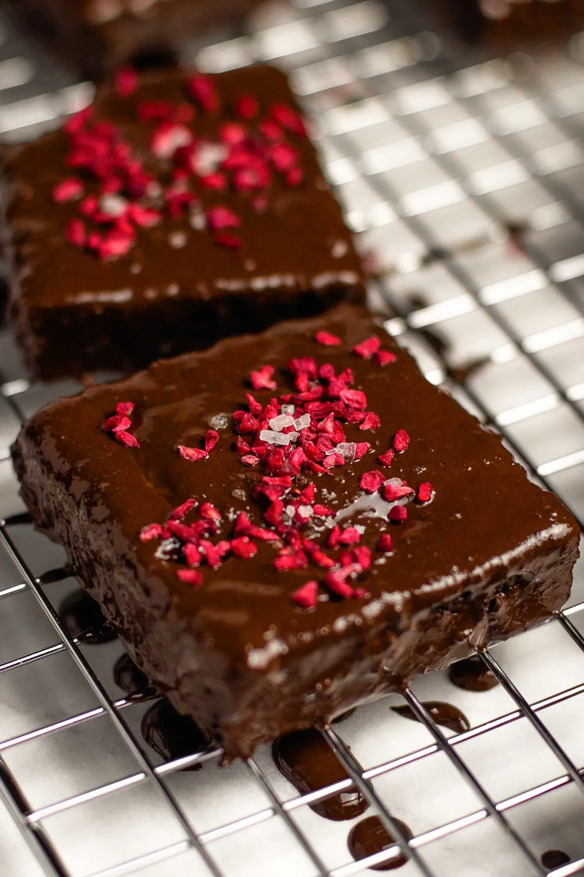 chocolate covered brownie topped with freeze dried raspberry 