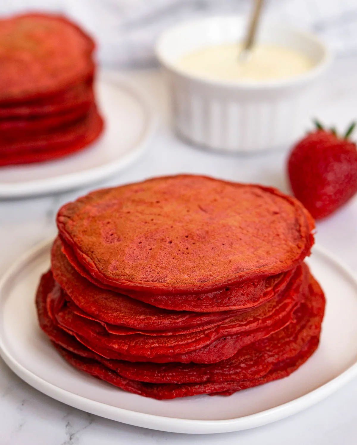 Stack of red pancakes on a plate/