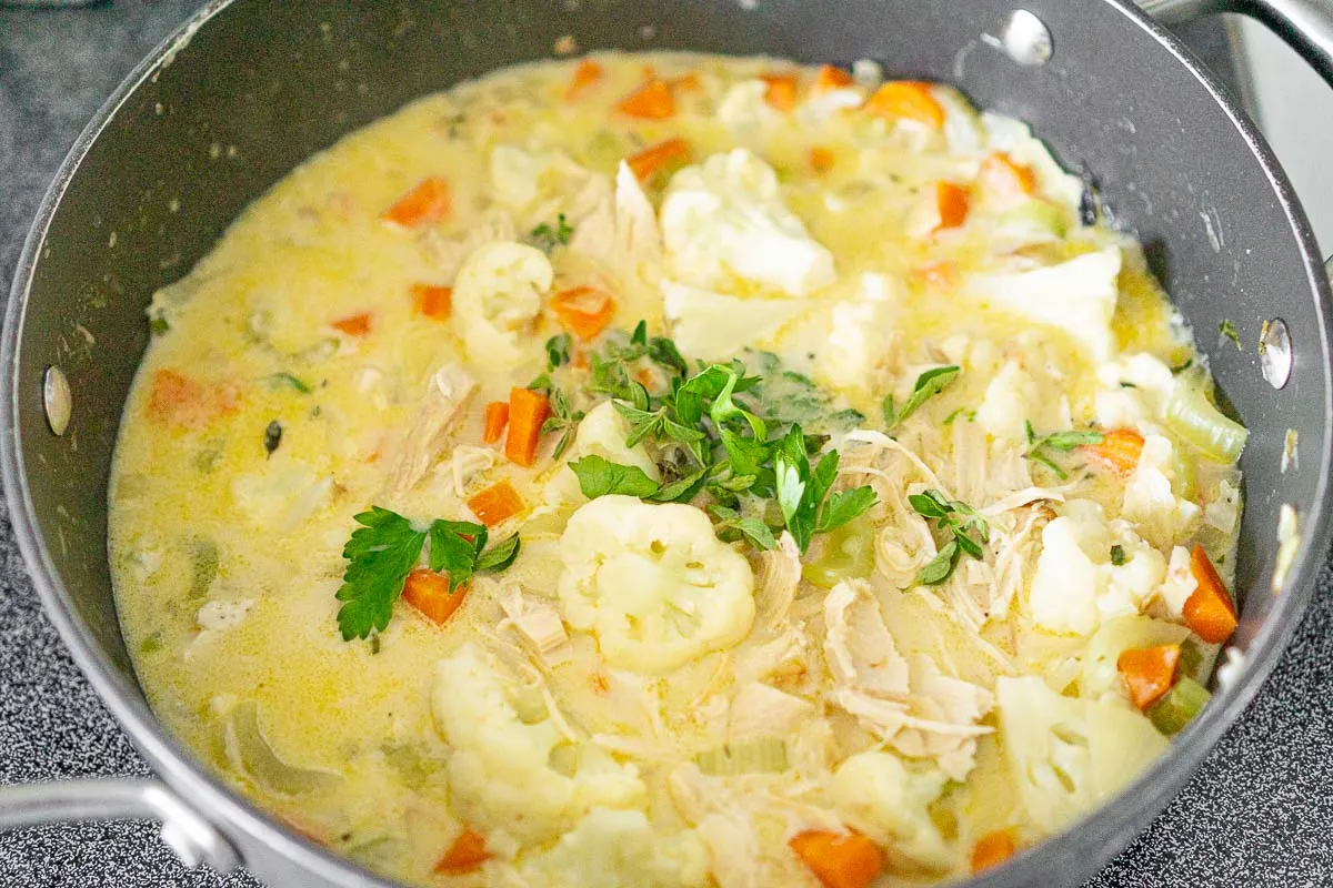 Adding herbs to chicken cauliflower soup