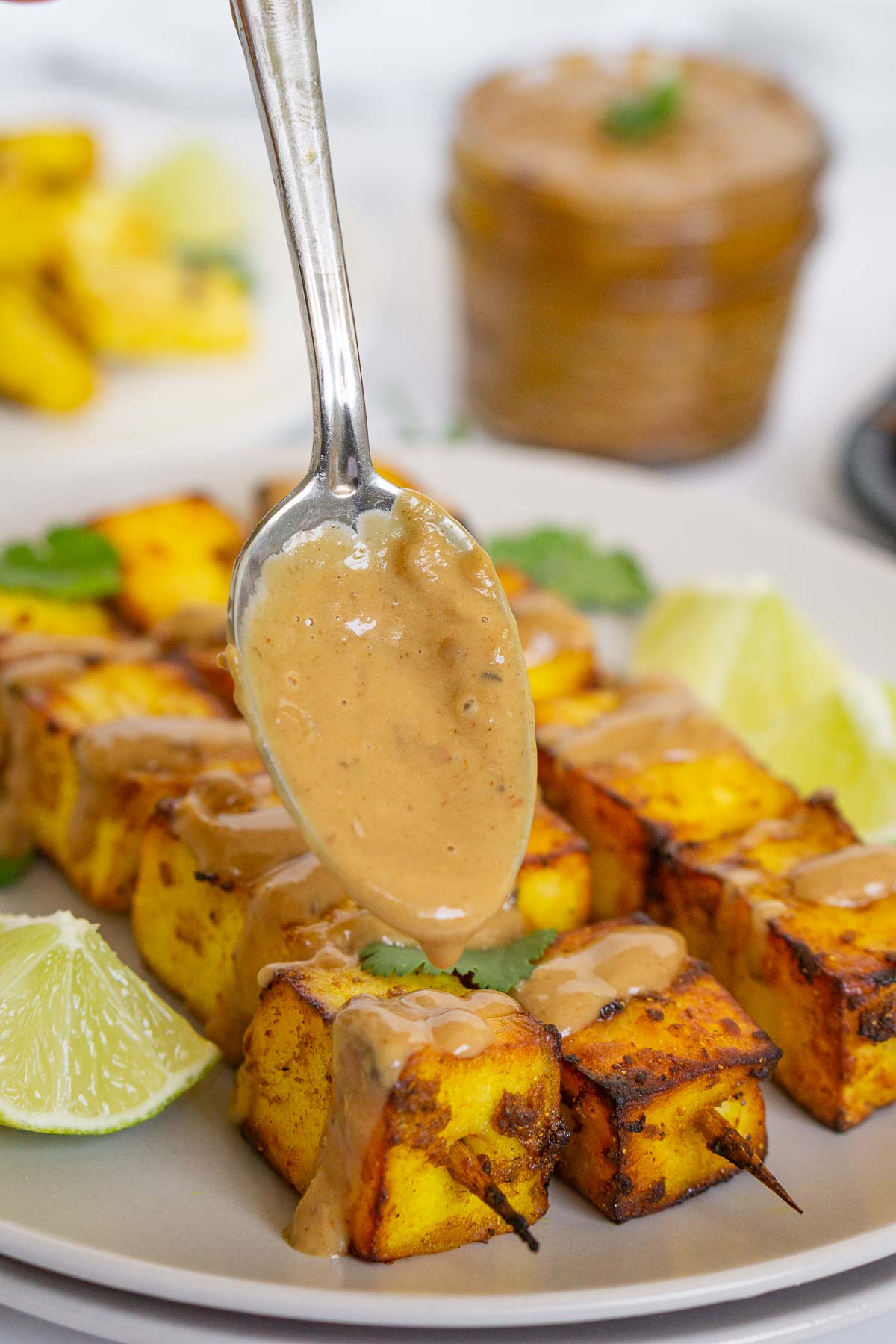 Drizzling paneer kebabs with peanut sauce