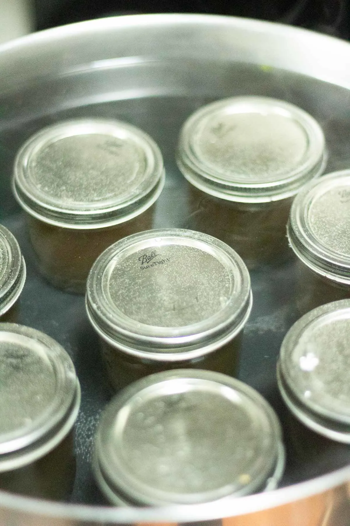 8 canning jars in a canning bath
