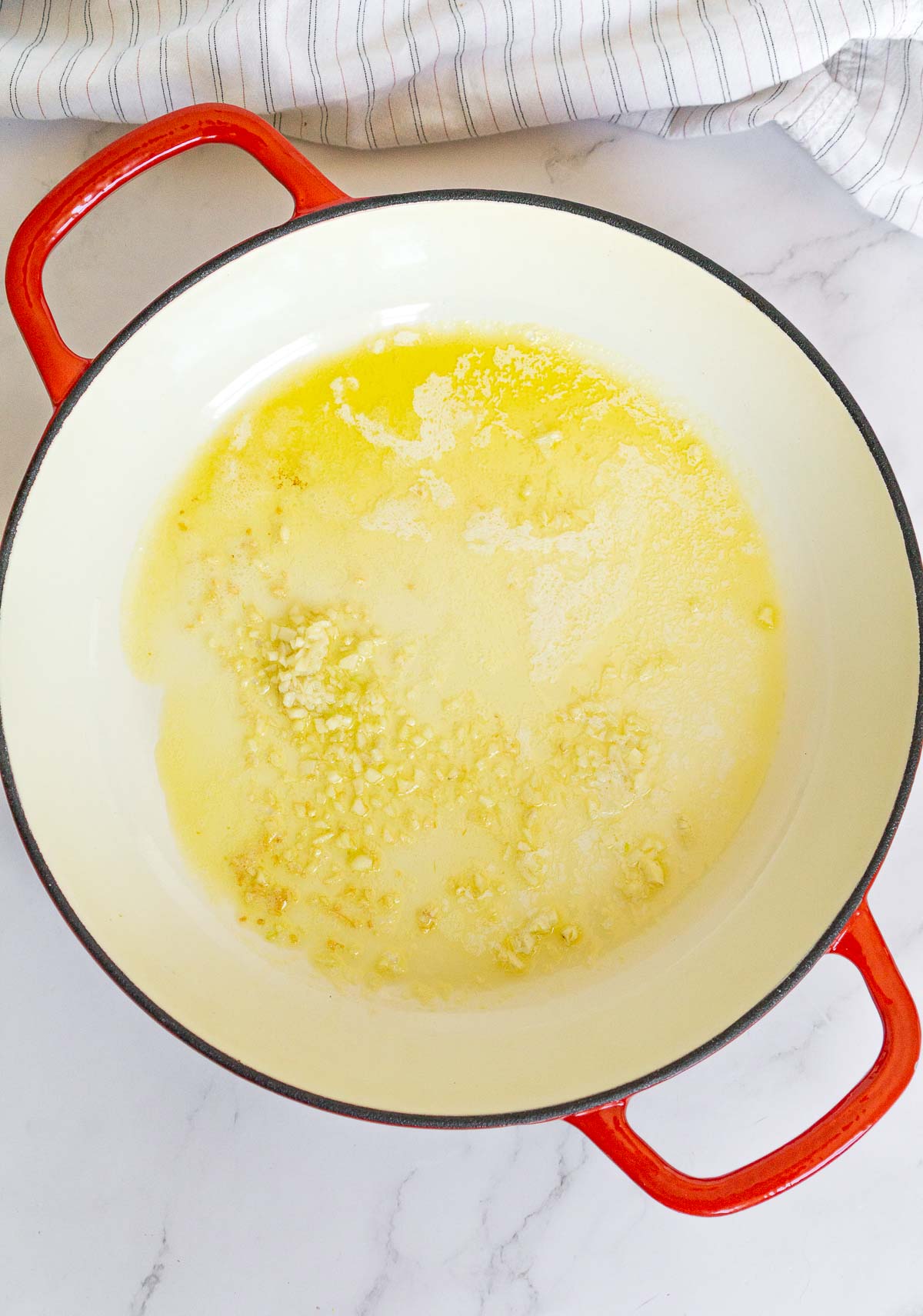 Melted butter, olive oil and minced garlic in a pan.